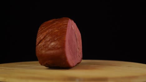 marbled meat cut of beef fast rotating on black background