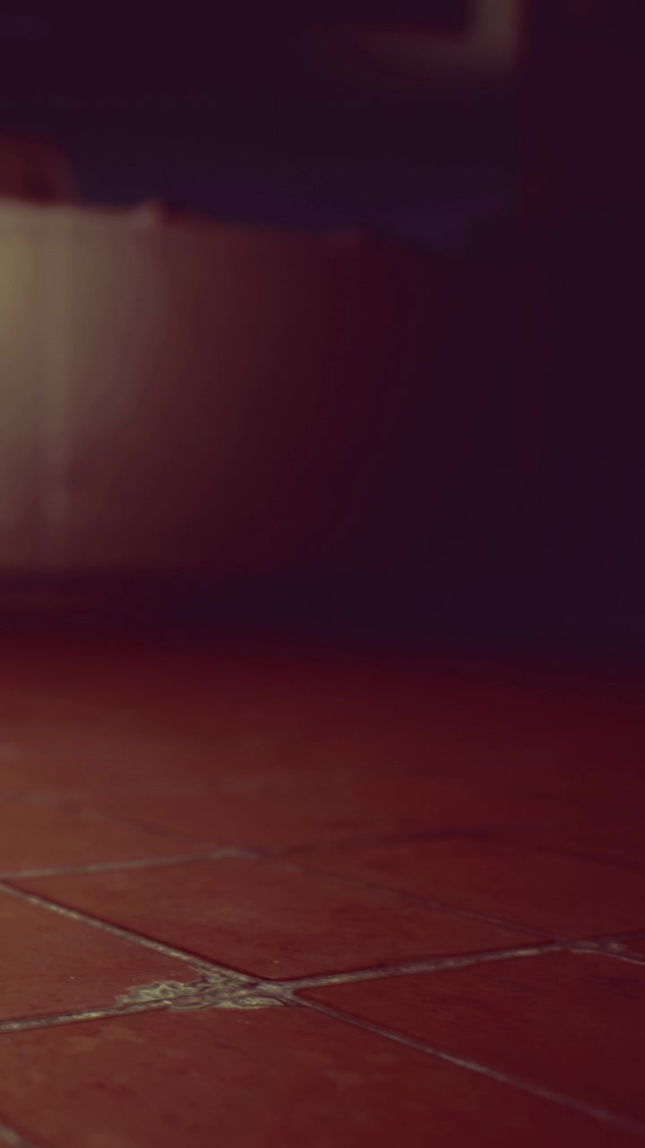 Quiet indoor space with tiled floor and soft light in the background