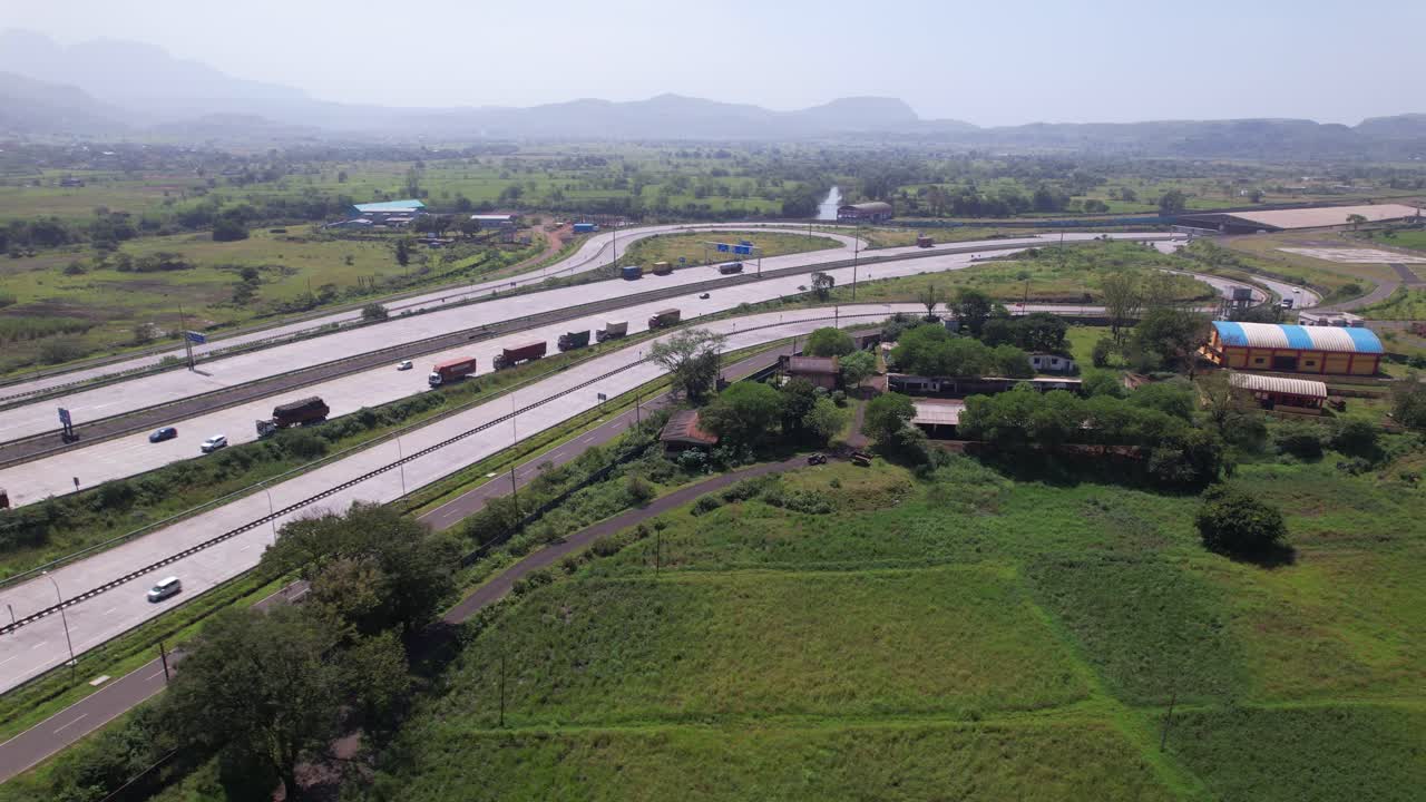 Samruddhi Mahamarg expressway connecting Mumbai and Nagpur through fertile agricultural fields, forest, Maharashtra, Drone shot