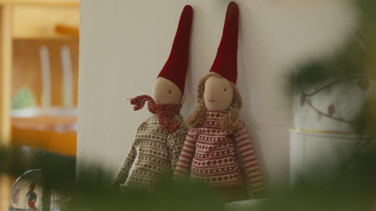 Festive fabric Scandinavian elves in traditional holiday attire on display