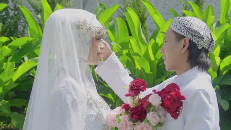 muslim couple bride and groom face each other at wedding