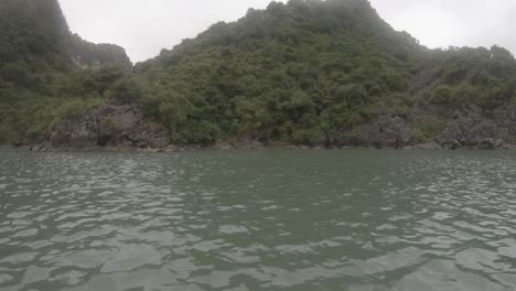 an island nestled within the stunning halong bay in vietnam, captured using a gopro from a kayak