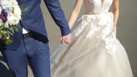 couple walking hand in hand on their wedding day