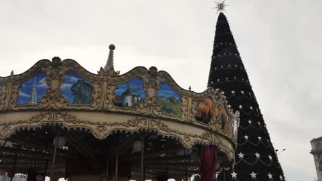 merry go round near a big christmas tree at the christmas market