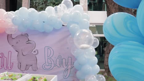 setting up the dessert table for a gender reveal celebration