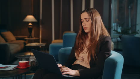 Tired-woman-working-laptop-computer-at-hotel-lounge.-Exhausted-businesswoman