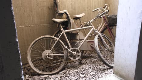 abandoned bikes with flat tires left leaning on