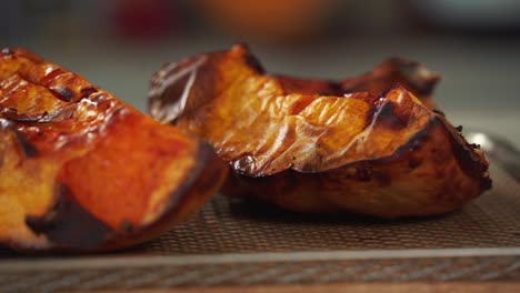 Close-up-shot-of-pumpkin-coming-out-the-oven-roasted-being-prepared-with-ingredients