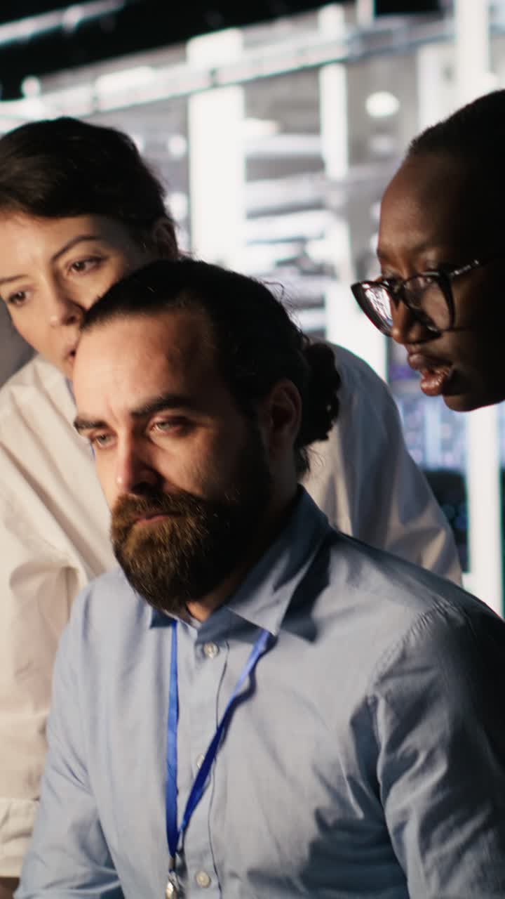 Vertical video Admins doing brainstorming in server hub, reviewing machine learning code