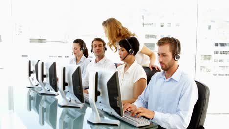 Supervisor-checking-on-call-centre-employees