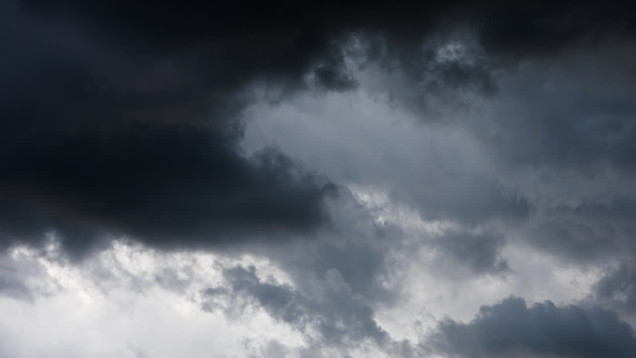 Looking up into dark clouds moving overhead