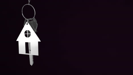 animation of silver house keys hanging against black background with copy space