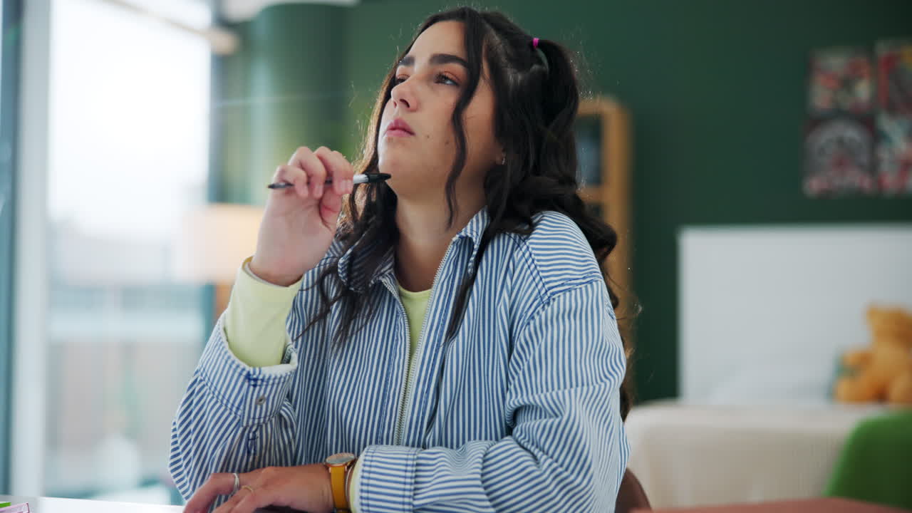 A woman with pen in hand thinking