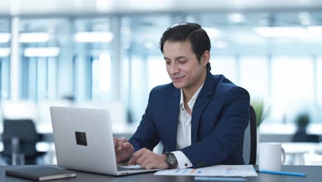 Happy-Indian-corporate-employee-working-on-laptop