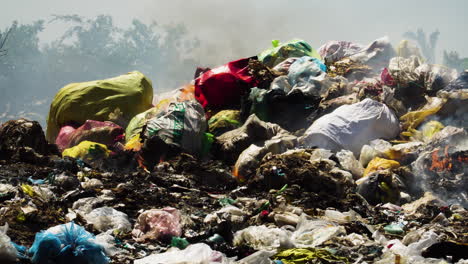 air pollution by illegal burning pile of plastic trash landfill in vietnam