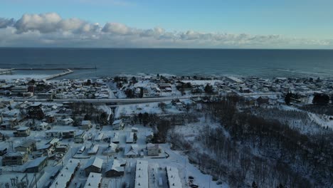 Drone-flying-backwards-over-coastal-town-on-Hokkaido-island-in-Japan