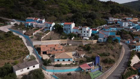 Beauty-of-Juzcar-township-in-mountains-of-Spain,-aerial-hyperlapse-view