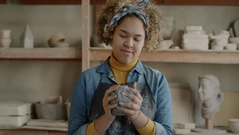 woman sculpting with clay in an art studio