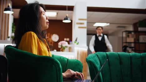 cliente del hotel resolviendo problemas en la computadora portátil en el área de salón