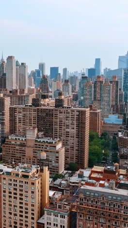 varied building architecture in the scenery of new york. multistoried houses at the backdrop of skyscrapers. vertical video