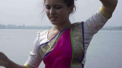 A-bharatnatyam-dancer-displaying-a-classical-bharatnatyam-pose-in-the-nature-of-Vadatalav-lake,-Pavagadh