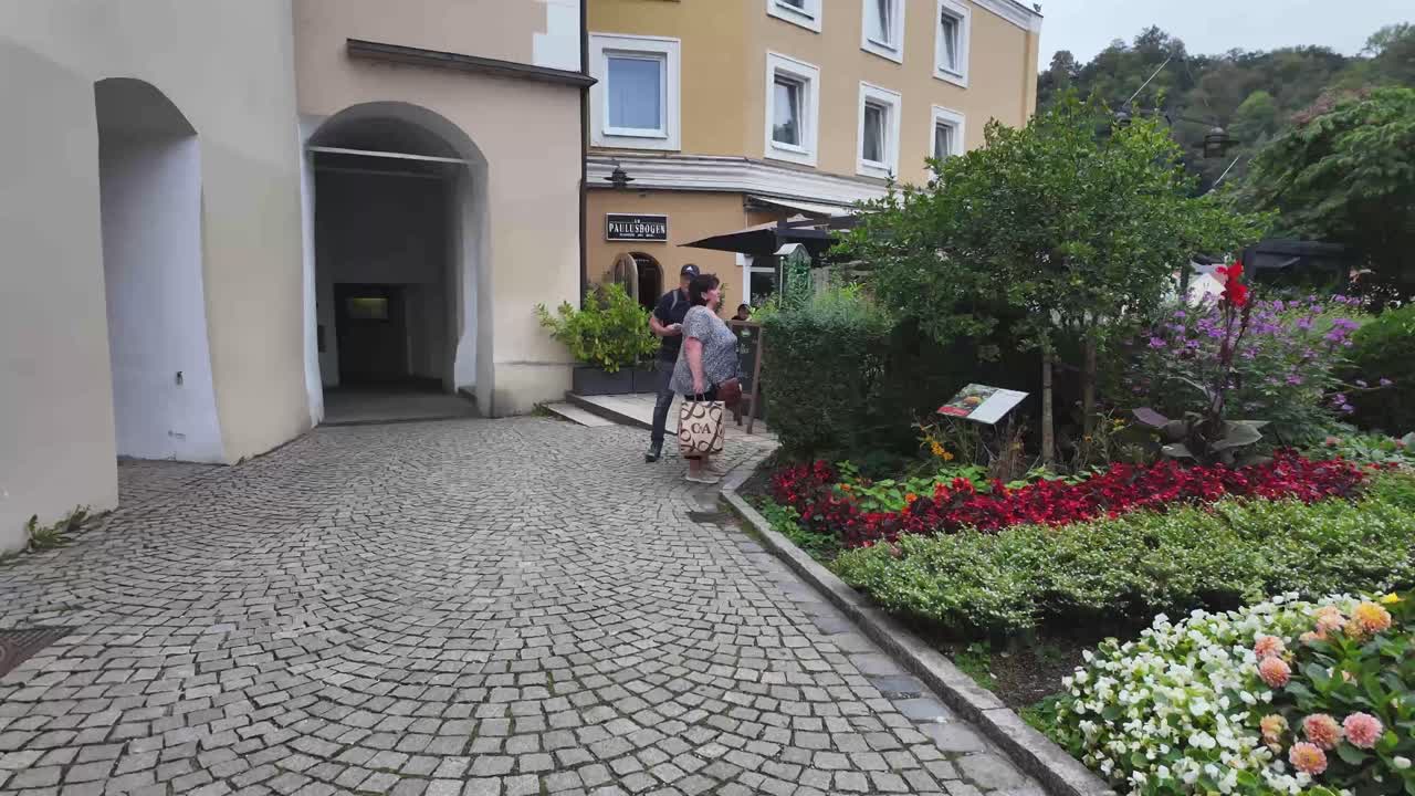 Small and beautiful city park, garden in old town Passau, Germany next to a restaurant.