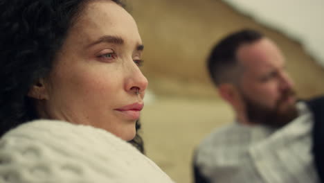 hispanic woman looking view on date. peaceful couple resting together on beach.