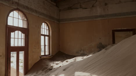 abandoned building buried in sand