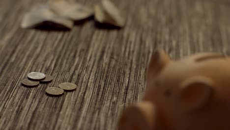 scattered coins and piggy bank