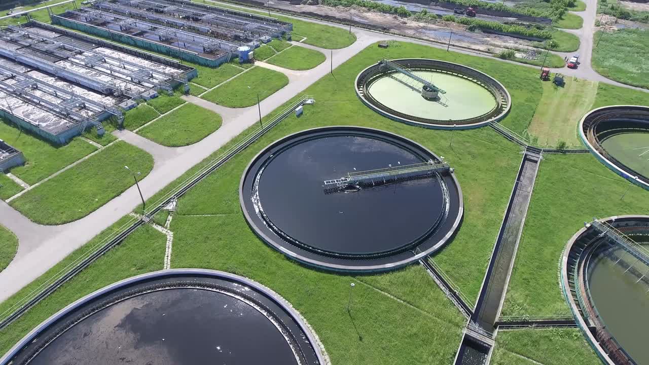 Sewage farm. Static aerial photo looking down onto the clarifying tanks and green grass.