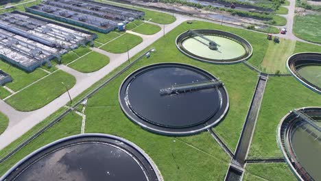 sewage farm. static aerial photo looking down onto the clarifying tanks and green grass.