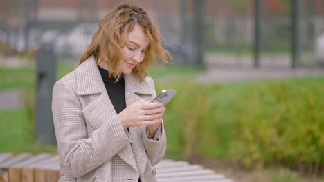 woman using phone in a park