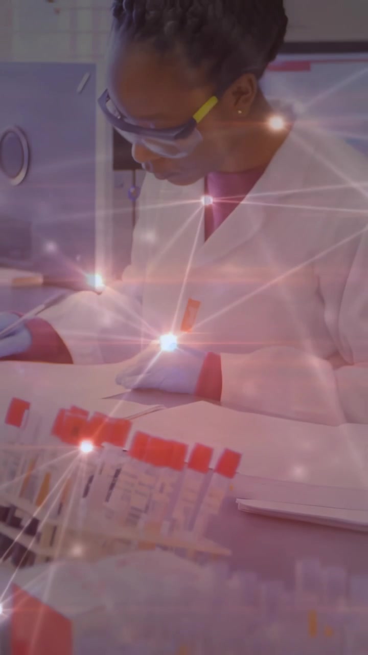 Vertical video: Cam pulling back showing lab tech checking red tubes and logging IDs with overlay