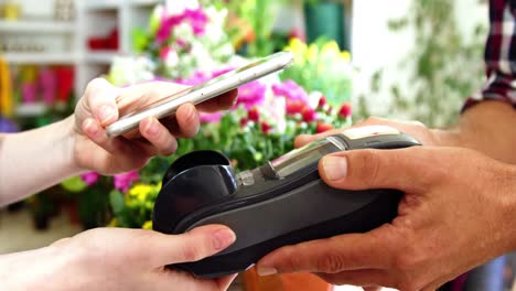 hand of customer making payment through smartphone