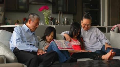 front view of multi-generation asian family using digital tablet in a comfortable home 4k