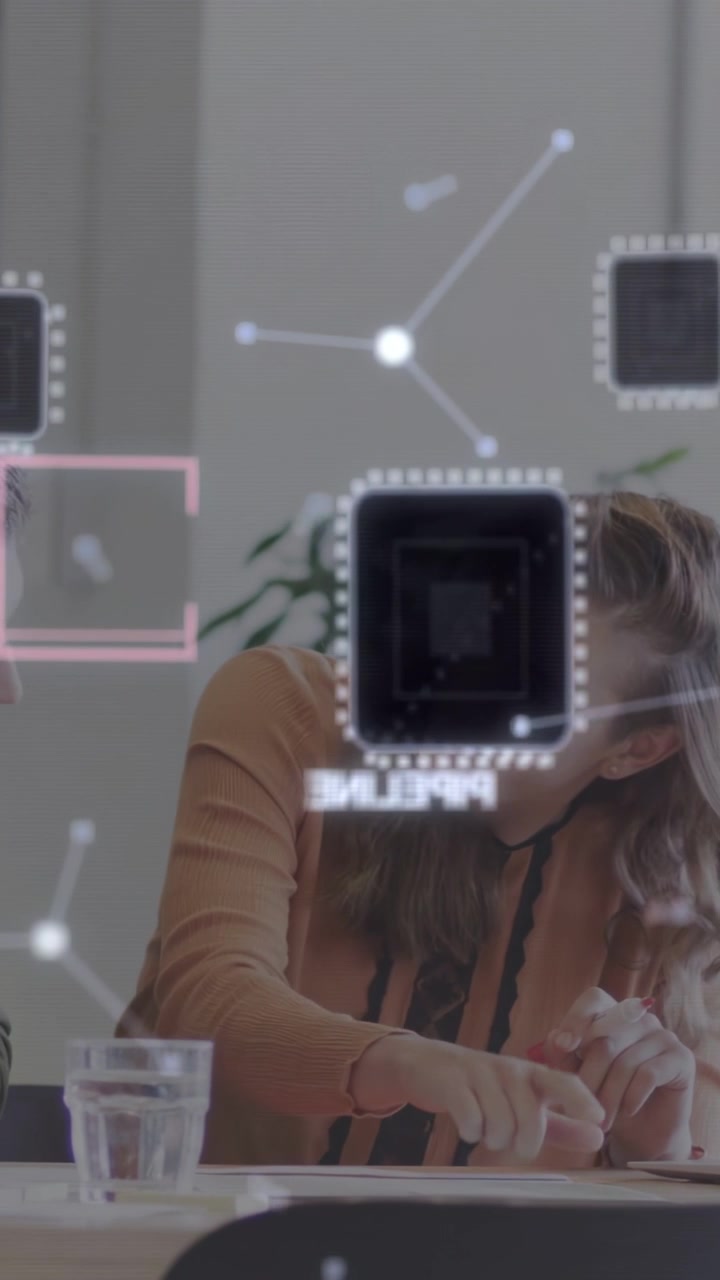 Vertical video: Woman tapping marker on paper causing AR nodes at tech meeting, man joining review