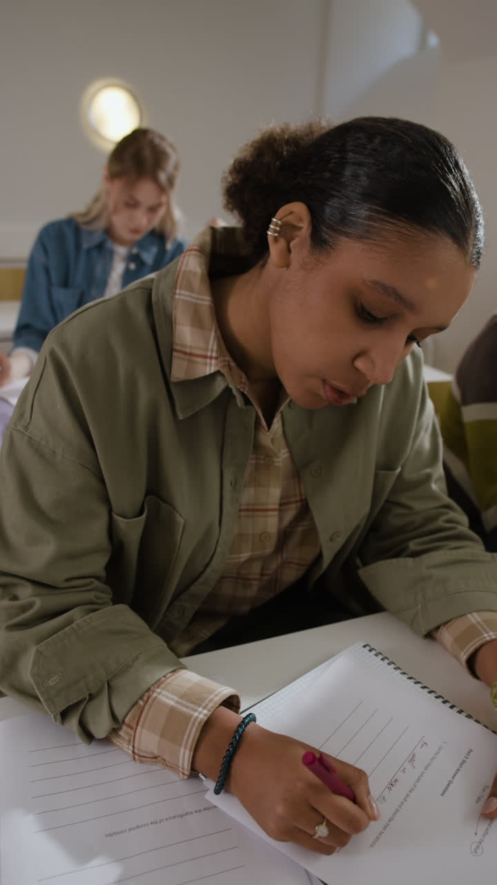 Students in a classroom taking an exam