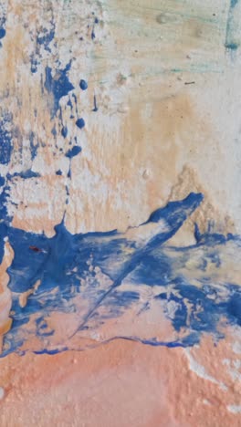 talented young artist painting on canvas with fingers and hands