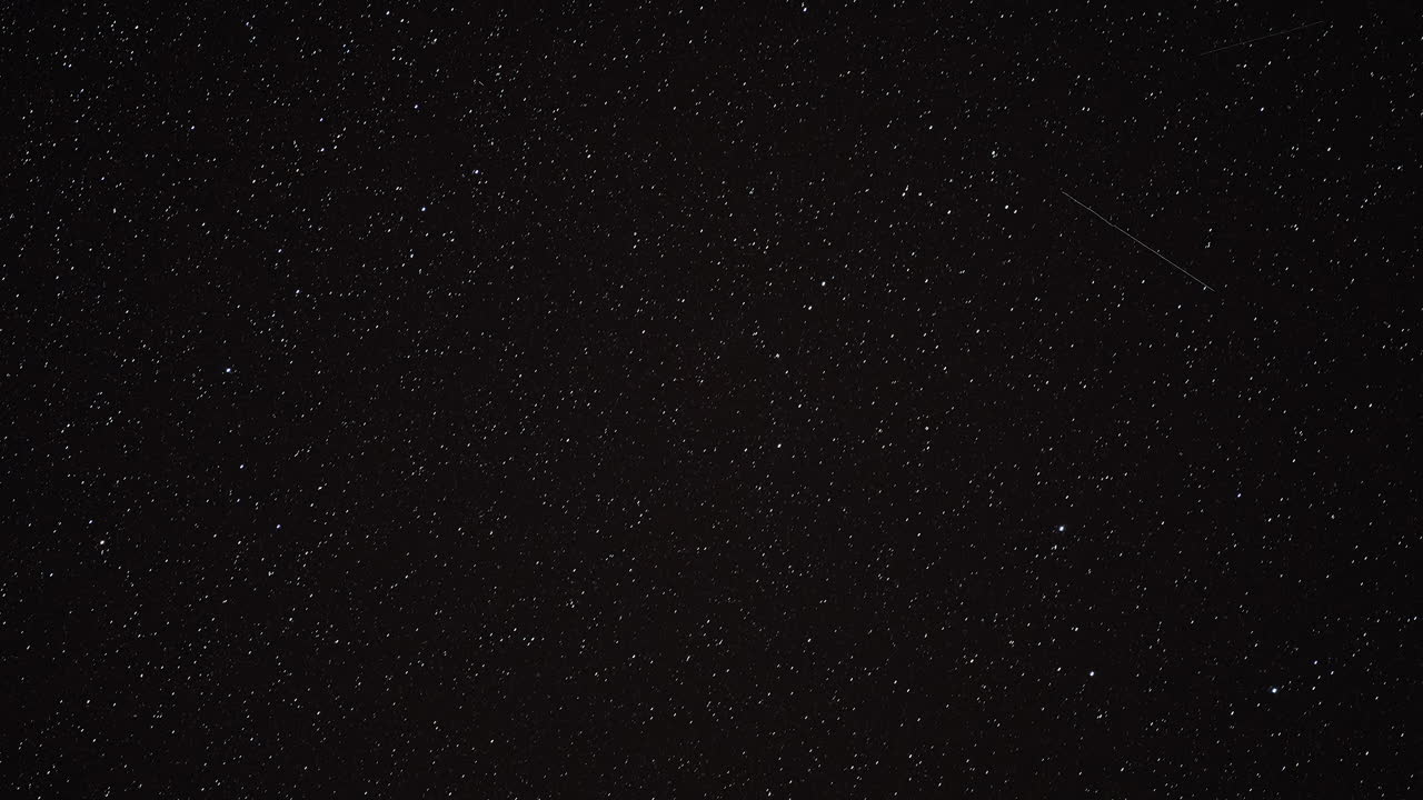 Stars and Galaxies Streak Across Dark Night Sky in Captivating Time Lapse