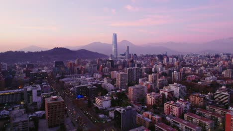 Aerial-view-dolly-out-establishing-of-Santiago-Chile-in-Providencia-residential-neighborhood-and-financial-center-with-the-Costanera-tower-at-sunset-in-the-background