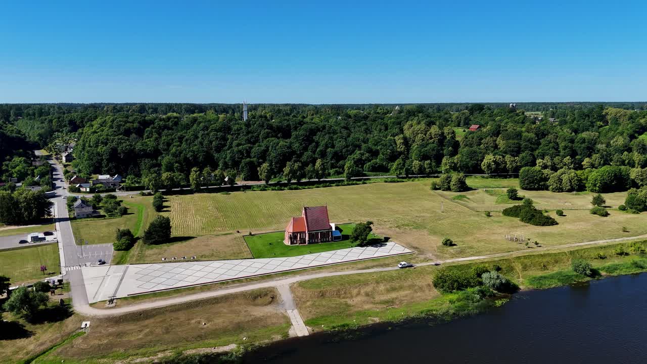 Aerial View of a Brick Church by the River