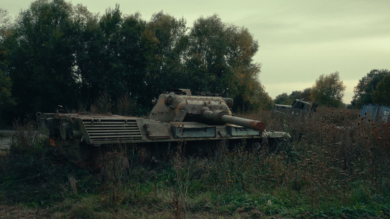 Abandoned Rusty Military Tank in Overgrown Field