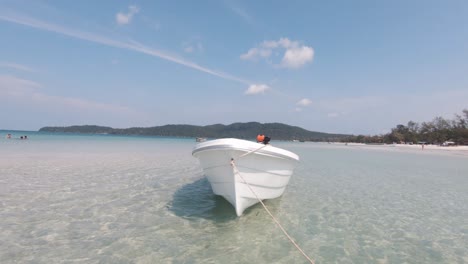 small white motor boat sitting in the tropical bay of koh rong samloem in cambodia