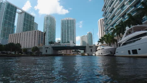 tall buildings and yachts line the coast of the waterways in miami florida