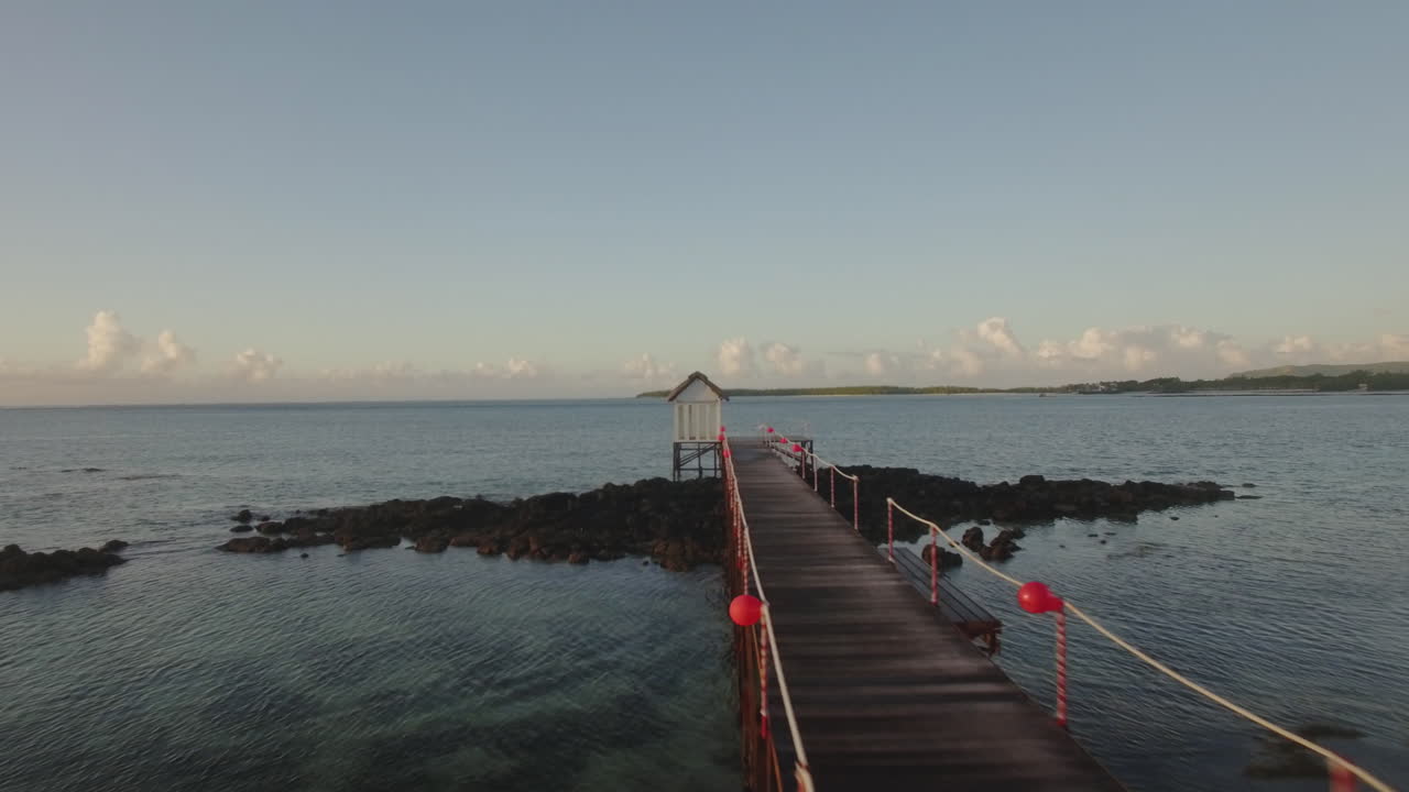 Flying over the wooden pier in water