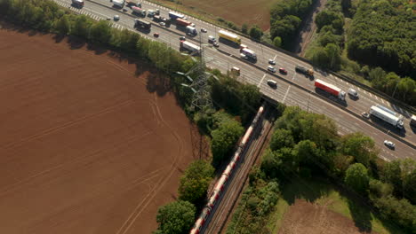 London-Underground-train-passing-under-busy-motorway-M25