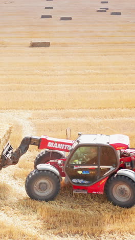 aerial view of tractor working in the field. agricultural summer farming field. vertical video