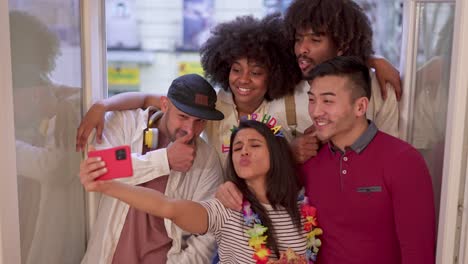 group of diverse friends celebrating a birthday and taking a selfie