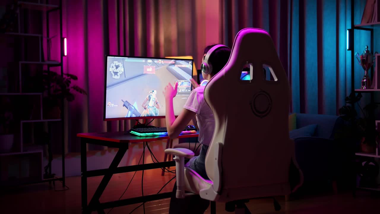 Asian Teen Girl Gamer Lose While Playing Video Game On Computer, Shooter Online Video Game