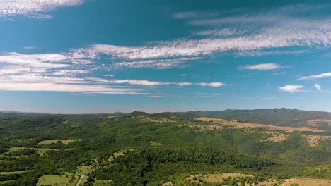 deep horizont panning shot of green valey and blue sky, kotel, bulgaria - october 15th, 2018